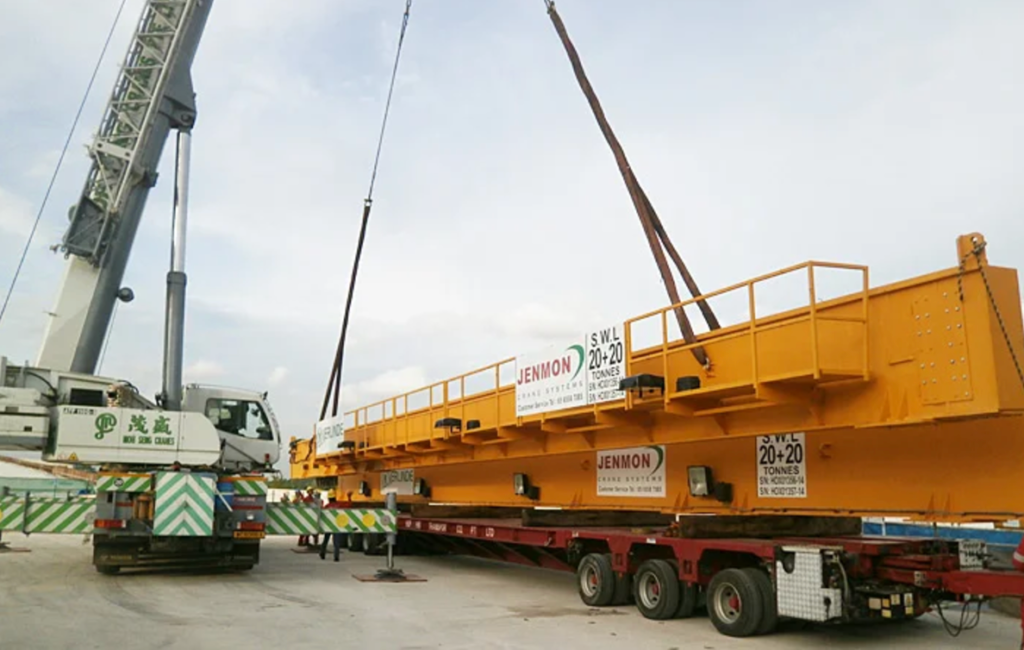 A big crane being transported using a machine