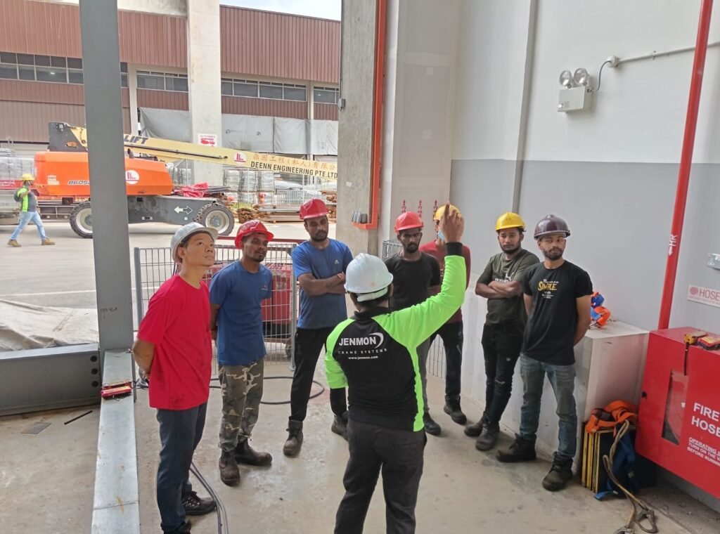 A male crane trainer with a team of operators