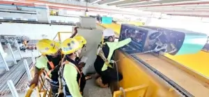 A group of certified inspectors is checking a crane