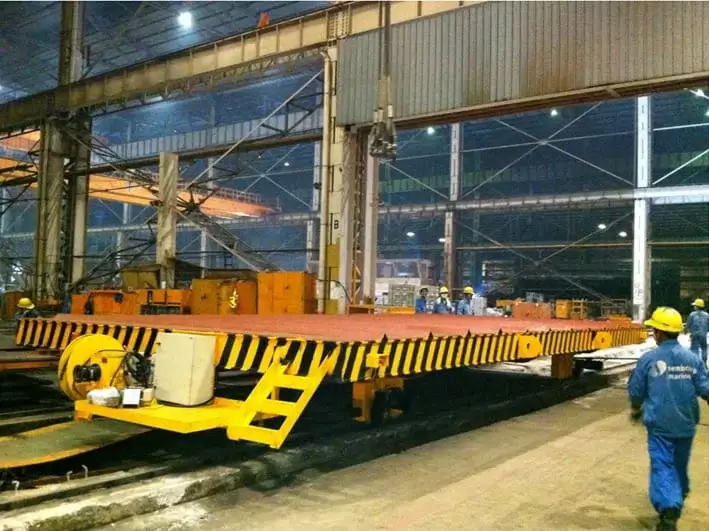 A transfer car on a rail used for transferring heavy objects on site