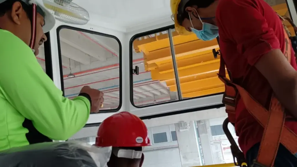 A crane trainer helping an operator understand the basic hands-on practical test